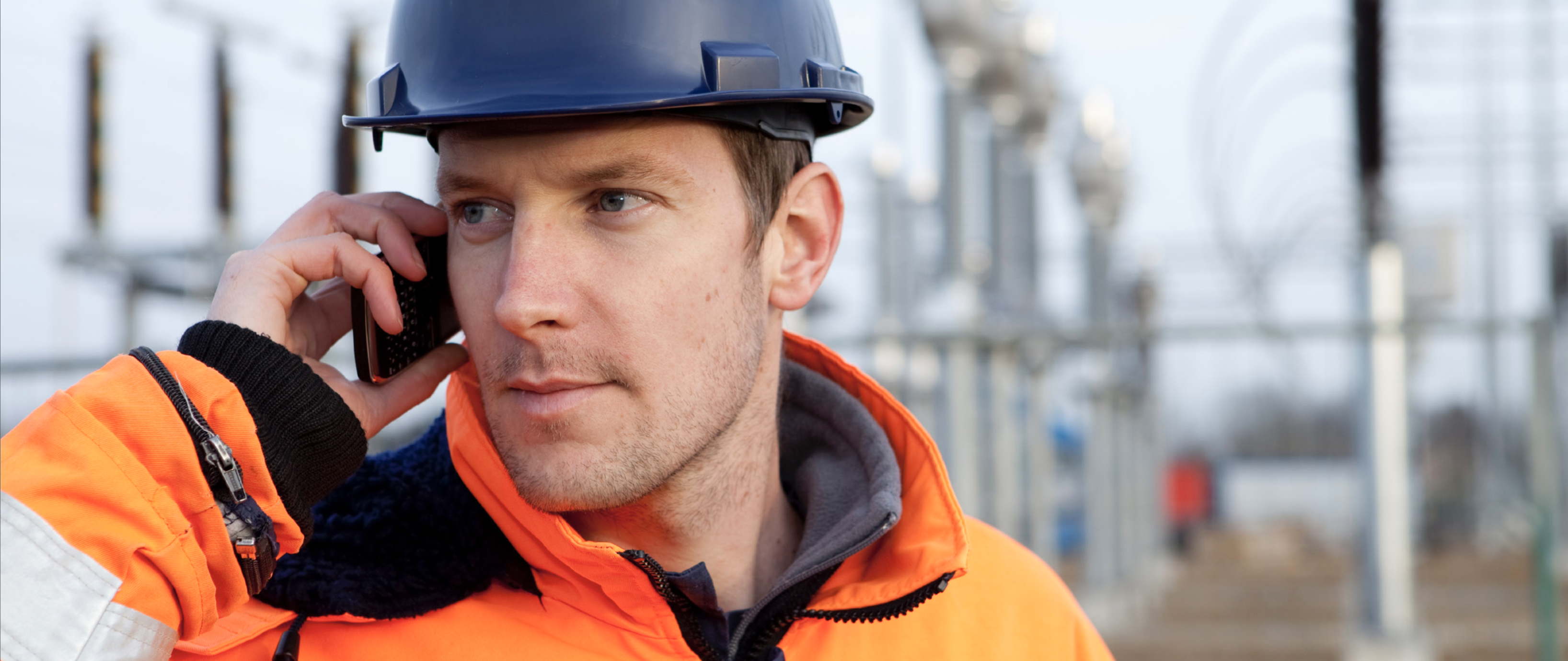 Man with hardhat on cell phone